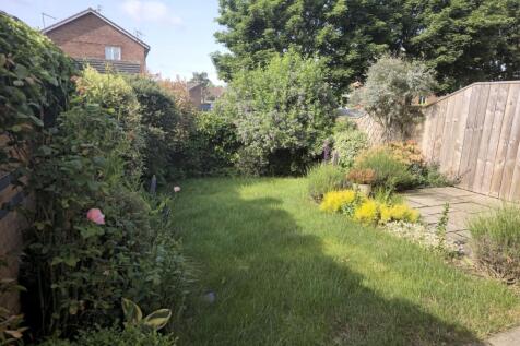A beautifully maintained garden featuring lush ...