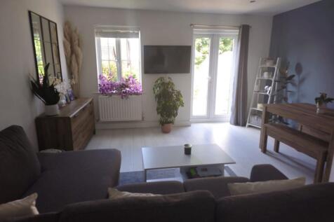 A bright and contemporary living room featuring...