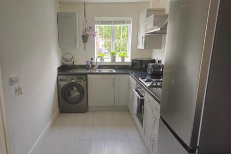 Bright and modern galley kitchen featuring slee...