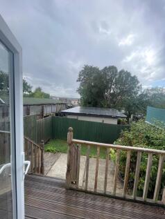 A peaceful garden area viewed from a wooden dec...