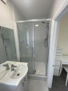 A clean and modern bathroom featuring a white s...