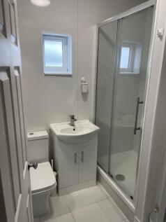 A neat and modern bathroom featuring a compact ...