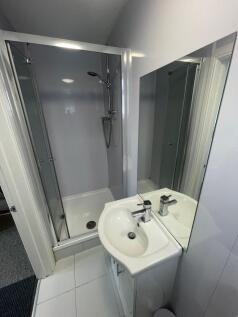 A neat and modern bathroom featuring a shower e...