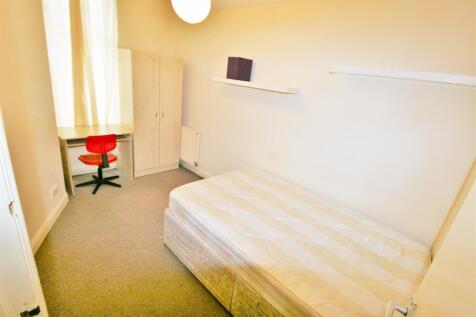 A bright and tidy single bedroom featuring a co...