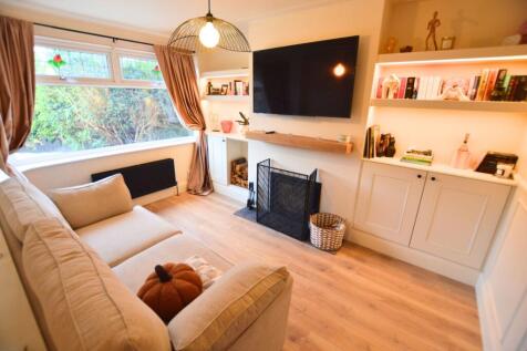 Bright and cozy living room featuring a large w...