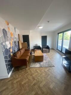 A modern living room featuring a stylish brown ...
