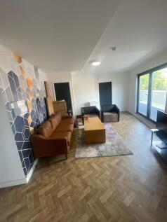A modern living room featuring stylish wooden h...