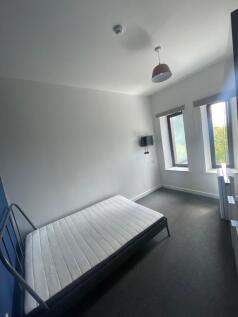 A neat and bright double bedroom featuring two ...