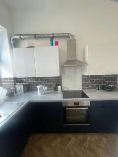 Modern kitchen featuring a sleek electric hob a...