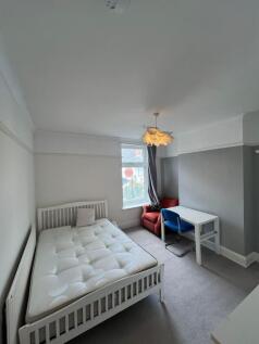 Bright and cozy double bedroom featuring a comf...