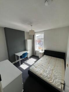 A bright and neat double bedroom featuring a co...