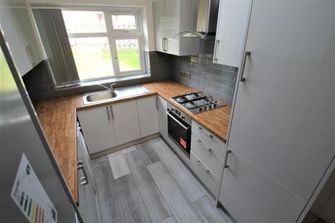 Modern kitchen with natural light streaming thr...