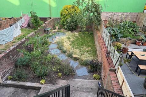 A charming and well-maintained garden space fea...