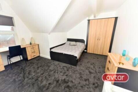 A bright and tidy master bedroom featuring a do...