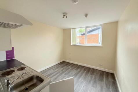A bright and tidy kitchen space featuring moder...