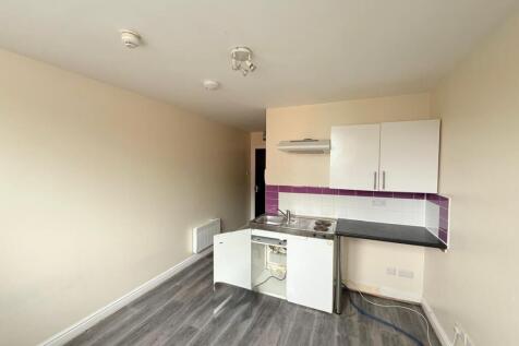 A compact kitchen area featuring clean laminate...