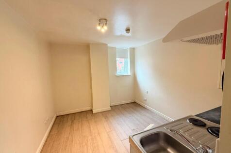 A compact kitchen area featuring a stainless st...