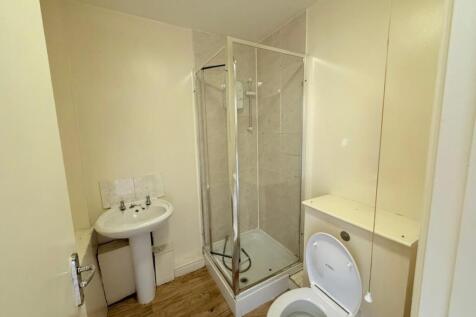 A functional bathroom featuring a shower cubicl...