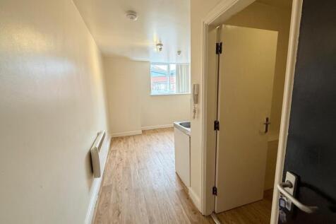 A clean and well-maintained hallway with wood-e...
