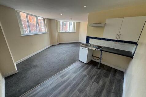 Bright open-plan studio room with bay windows, ...