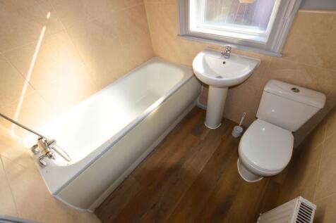 Bright and clean bathroom suite featuring a cla...