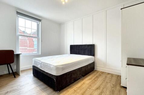 Bright and spacious double bedroom featuring a ...