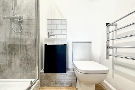 A modern bathroom featuring a sleek shower, sty...