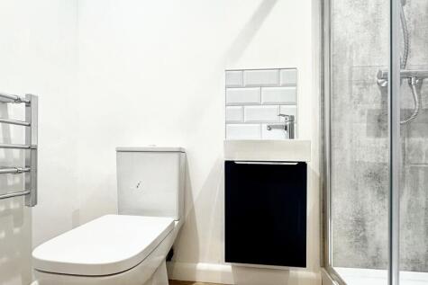 A modern bathroom featuring a sleek shower and ...