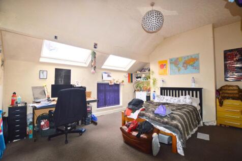 Bright and spacious attic bedroom featuring sky...
