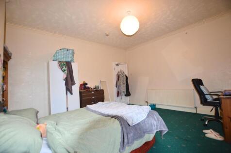 A comfortable double bedroom with a cozy bed, p...
