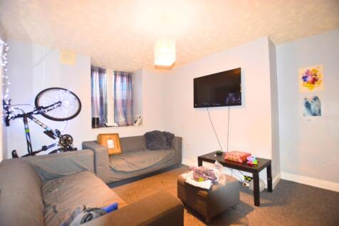 A cozy living room featuring two grey sofas and...