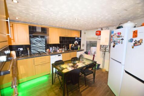 A functional kitchen featuring light wood cabin...