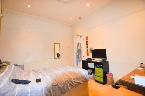 A cozy single bedroom featuring a comfortable b...