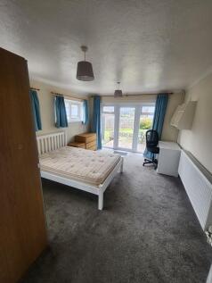 Spacious master bedroom featuring a comfortable...