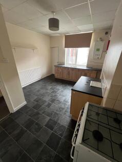 A functional kitchen space with ample black til...