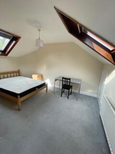 A bright double bedroom featuring two skylight ...