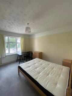 A bright and tidy double bedroom featuring a la...