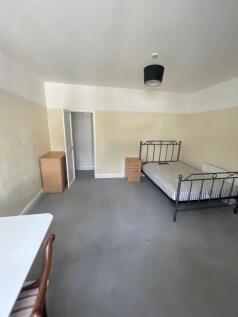 A spacious double bedroom featuring a sturdy me...