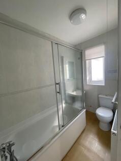 A clean and functional bathroom suite featuring...