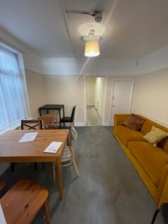 A cozy communal lounge featuring a mustard yell...
