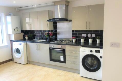 Bright, modern kitchen with sleek cabinetry, in...