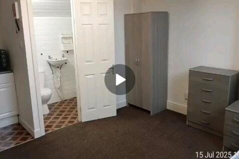 A neatly arranged double bedroom featuring a wa...