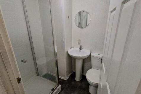 A neat and functional bathroom featuring a walk...