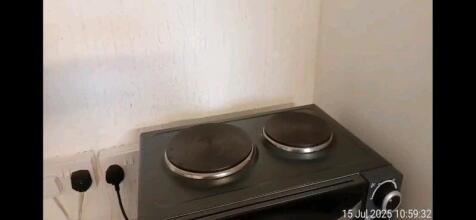 Compact kitchen area featuring a clean double h...