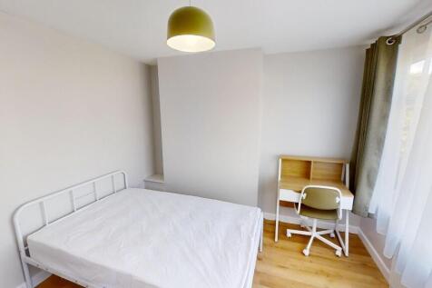 Bright and neat bedroom featuring a comfortable...