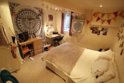 Cozy double bedroom featuring a comfortable bed...