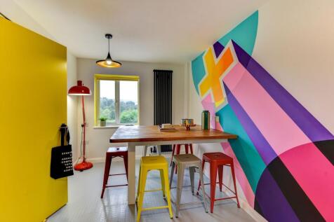 Bright and colorful communal workspace featurin...