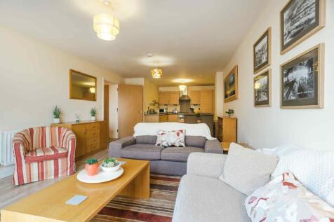 A bright and inviting living room featuring com...