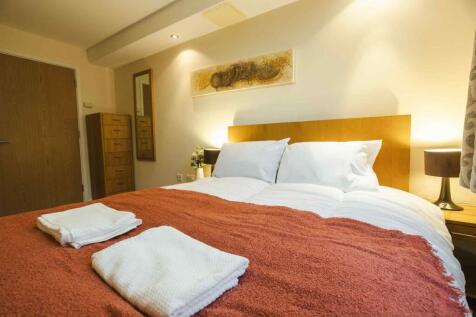 A warm and inviting master bedroom featuring a ...