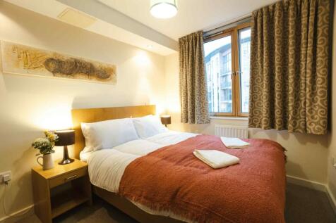 A cozy double bedroom featuring a comfortable d...